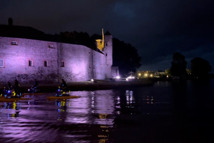 a castle with water in the dark