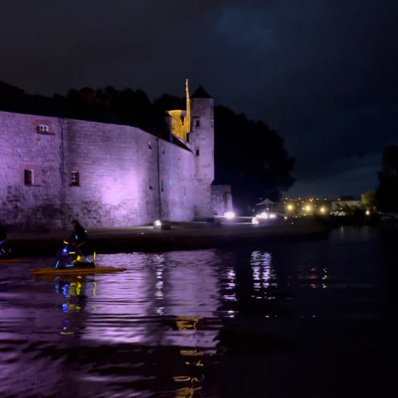 a castle with water in the dark