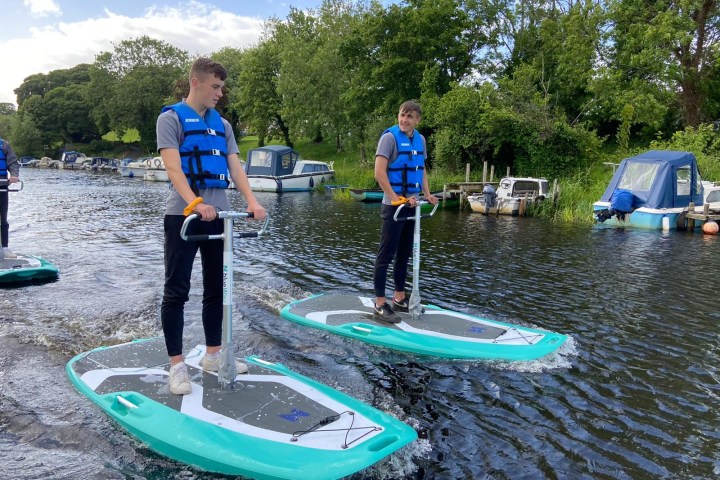 a group of people riding on the back of a boat