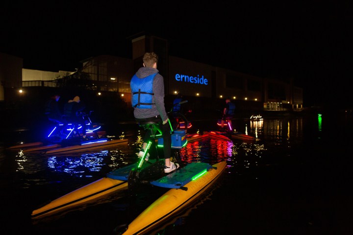 a man that is lit up at night